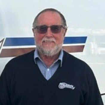 Peter Ogden in front of an Ogden's Coaches coach